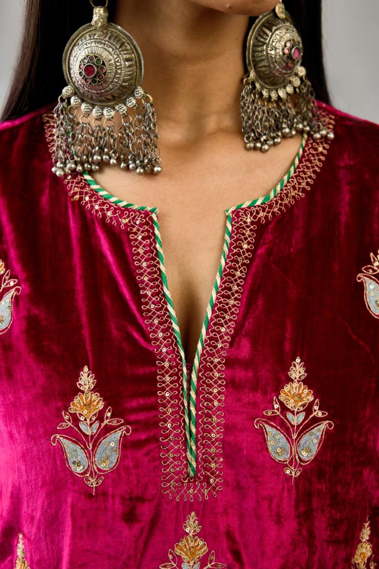 Fuchsia silk velvet A-line short kurta set with dori and contrast silk thread embroidery, highlighted with gold sequins work.