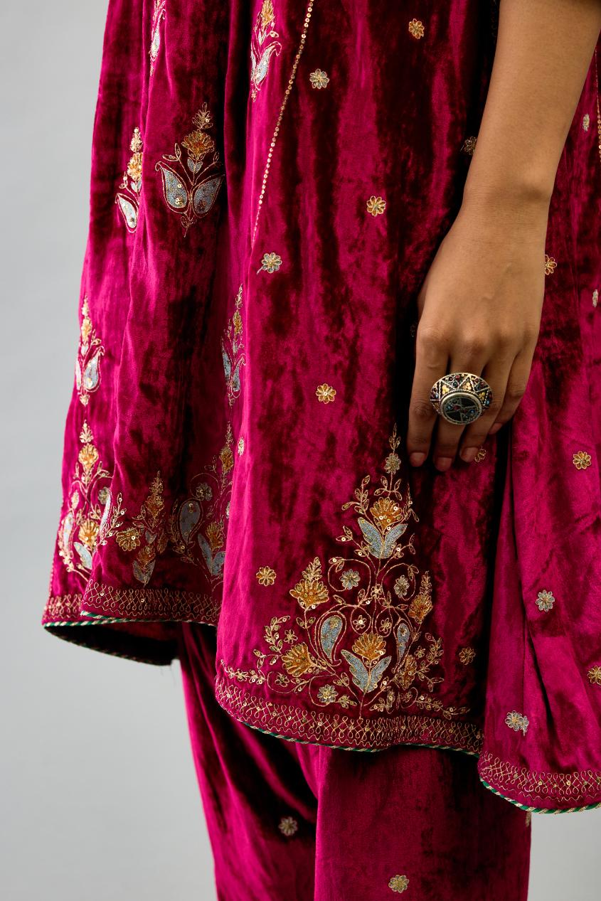 Fuchsia silk velvet A-line short kurta set with dori and contrast silk thread embroidery, highlighted with gold sequins work.