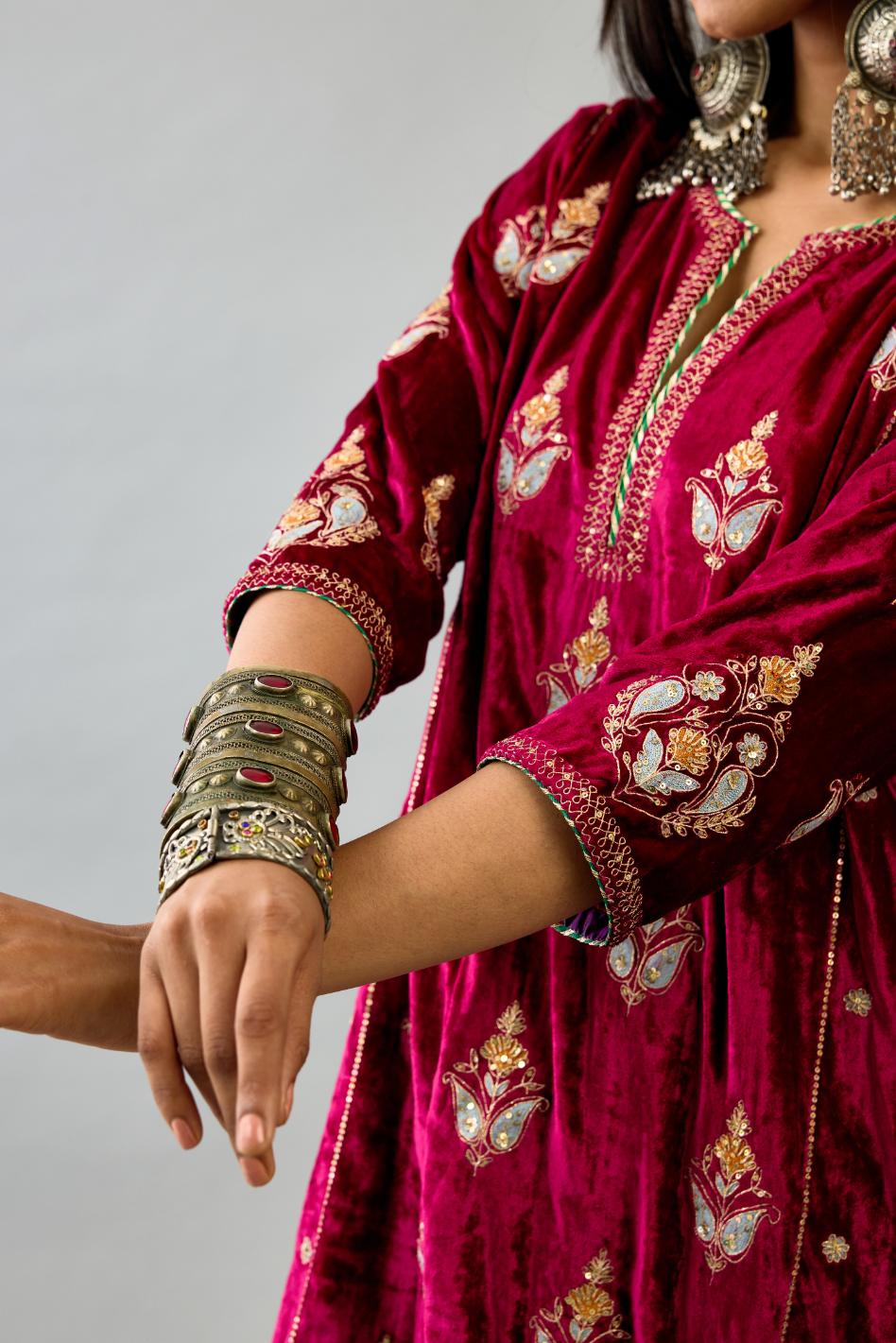 Fuchsia silk velvet A-line short kurta set with dori and contrast silk thread embroidery, highlighted with gold sequins work.