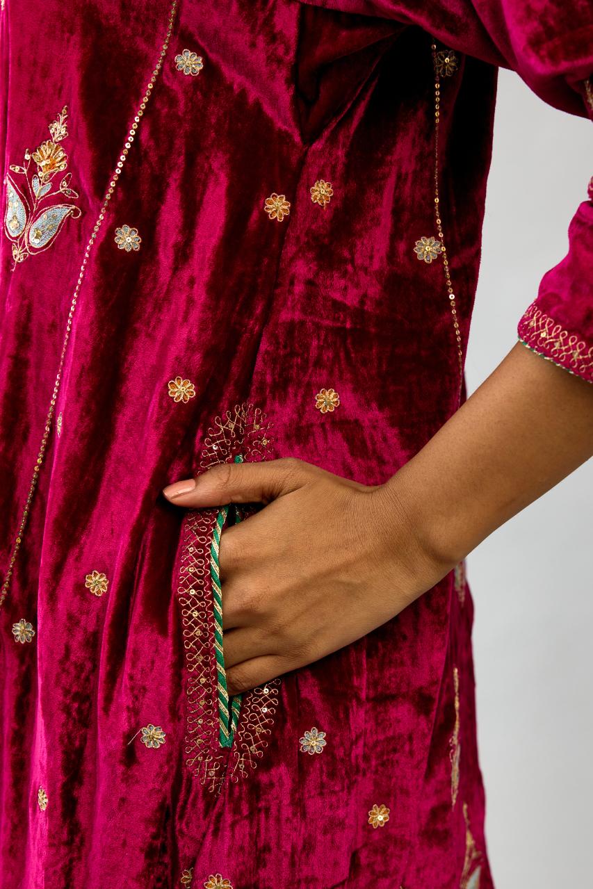 Fuchsia silk velvet A-line short kurta set with dori and contrast silk thread embroidery, highlighted with gold sequins work.