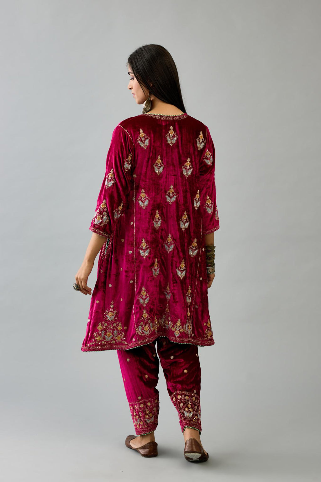 Fuchsia silk velvet A-line short kurta set with dori and contrast silk thread embroidery, highlighted with gold sequins work.