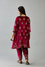 Fuchsia silk velvet A-line short kurta set with dori and contrast silk thread embroidery, highlighted with gold sequins work.
