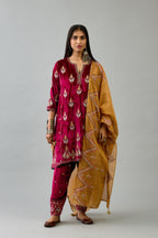 Fuchsia silk velvet A-line short kurta set with dori and contrast silk thread embroidery, highlighted with gold sequins work.