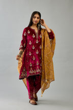 Fuchsia silk velvet A-line short kurta set with dori and contrast silk thread embroidery, highlighted with gold sequins work.