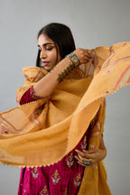 Fuchsia silk velvet A-line short kurta set with dori and contrast silk thread embroidery, highlighted with gold sequins work.