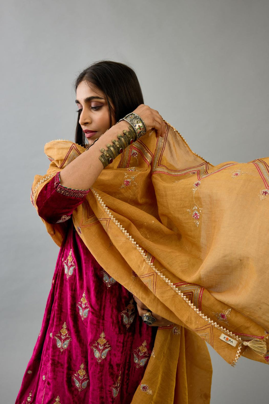 Golden yellow tissue chanderi dupatta in chevron pattern embroidery with contrast silk thread and dori at the sides.