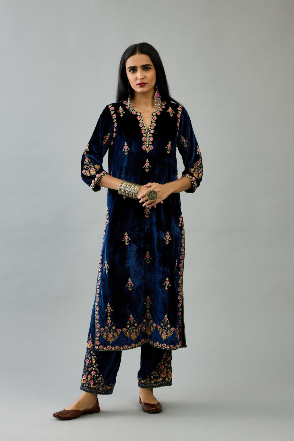 Blue silk velvet straight kurta set with all-over zari, dori and contrast silk thread embroidery, highlighted with gold sequins work.
