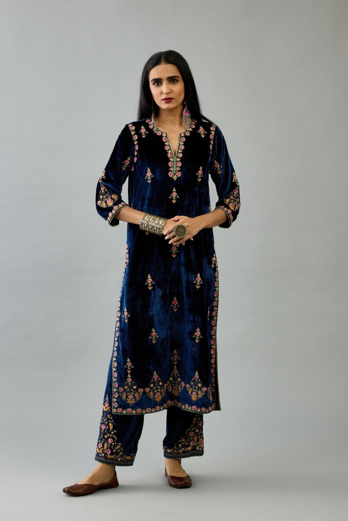 Blue silk velvet straight kurta set with all-over zari, dori and contrast silk thread embroidery, highlighted with gold sequins work.