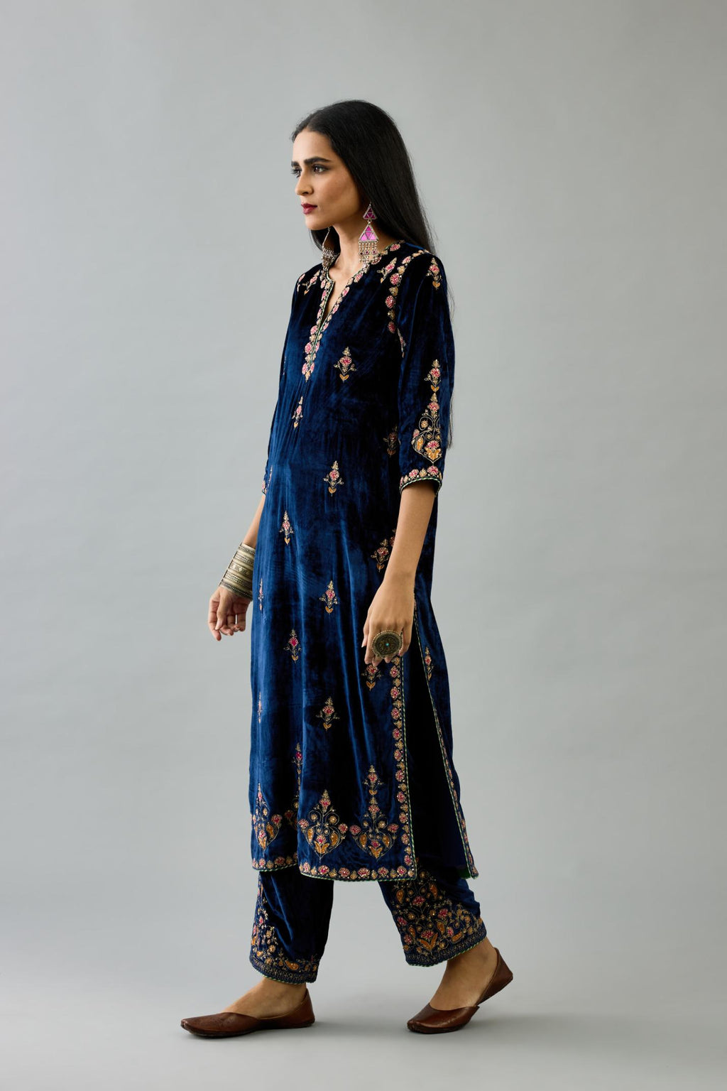 Blue silk velvet straight kurta set with all-over zari, dori and contrast silk thread embroidery, highlighted with gold sequins work.