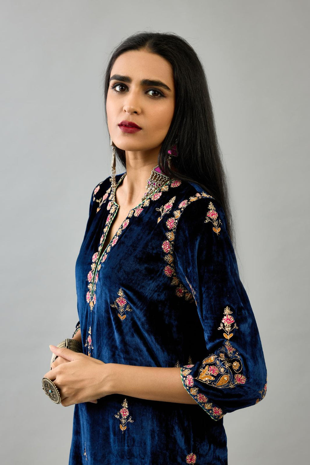 Blue silk velvet straight kurta set with all-over zari, dori and contrast silk thread embroidery, highlighted with gold sequins work.