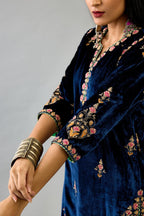Blue silk velvet straight kurta set with all-over zari, dori and contrast silk thread embroidery, highlighted with gold sequins work.
