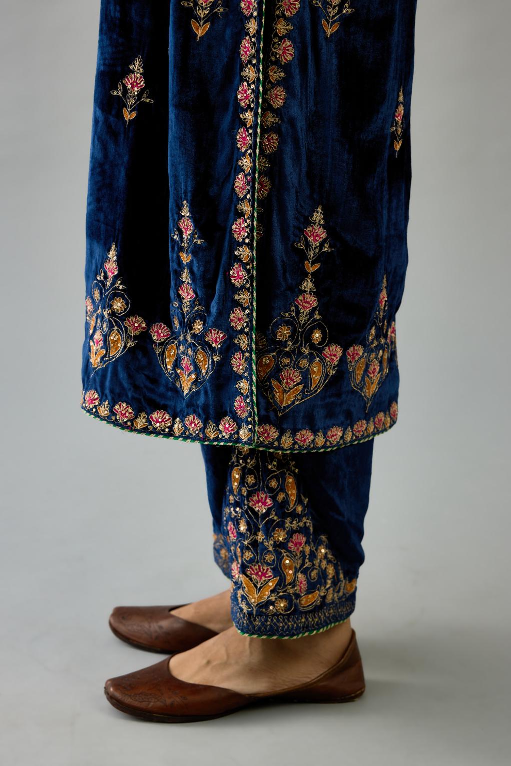 Blue silk velvet straight kurta set with all-over zari, dori and contrast silk thread embroidery, highlighted with gold sequins work.