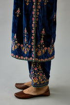 Blue silk velvet straight kurta set with all-over zari, dori and contrast silk thread embroidery, highlighted with gold sequins work.