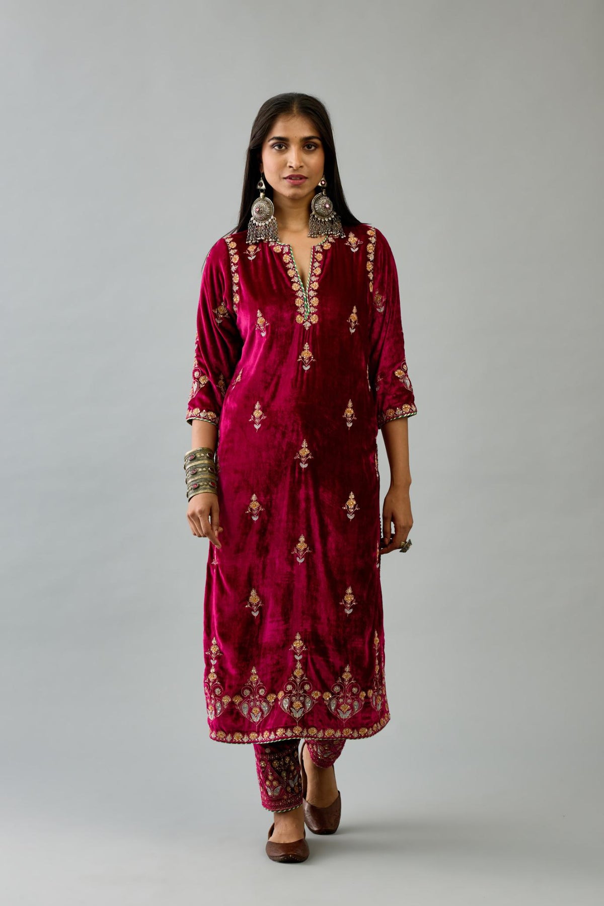 Fuchsia silk velvet straight kurta set with all-over zari, dori and contrast silk thread embroidery, highlighted with gold sequins work.