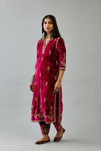 Fuchsia silk velvet straight kurta set with all-over zari, dori and contrast silk thread embroidery, highlighted with gold sequins work.