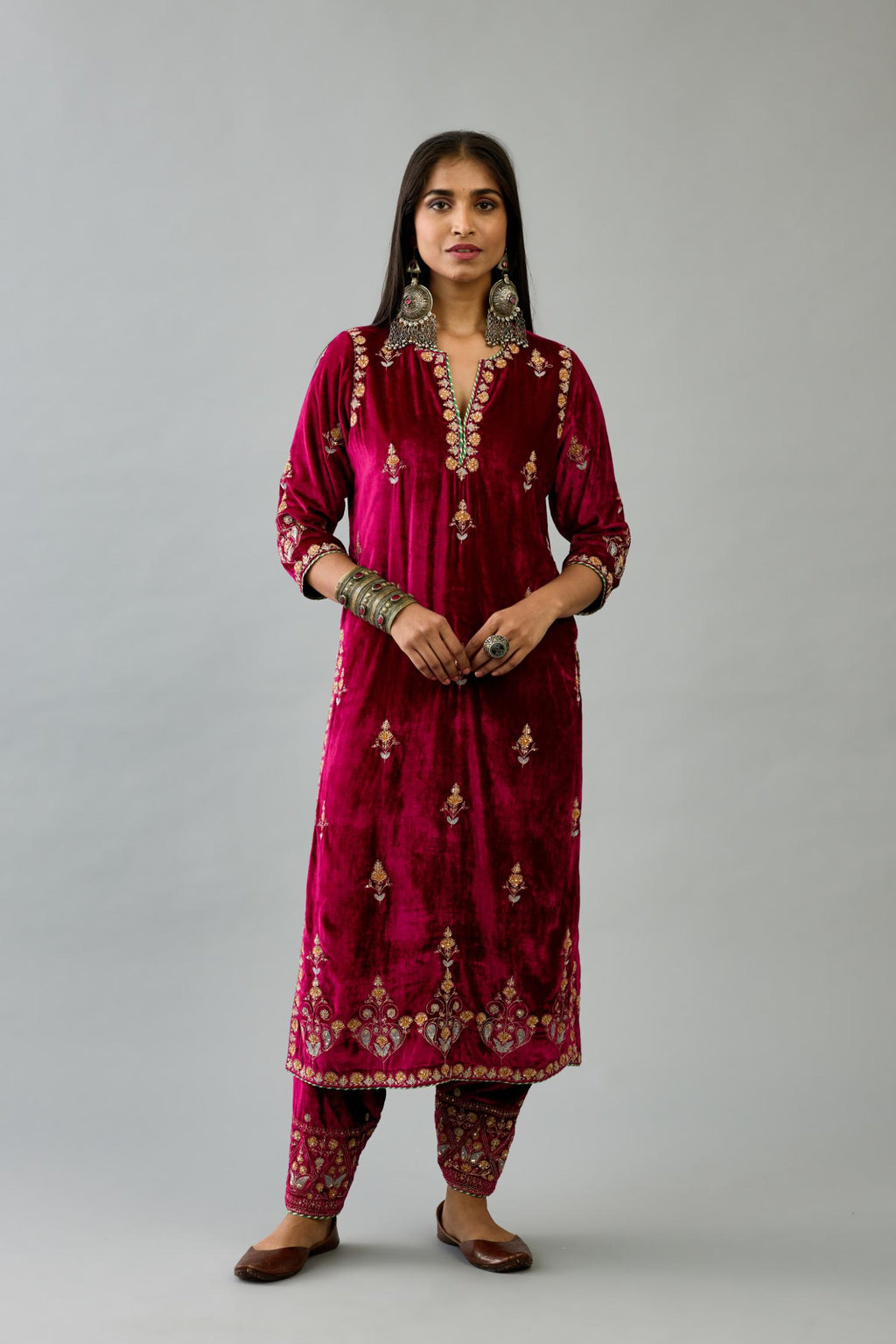Fuchsia silk velvet straight kurta set with all-over zari, dori and contrast silk thread embroidery, highlighted with gold sequins work.