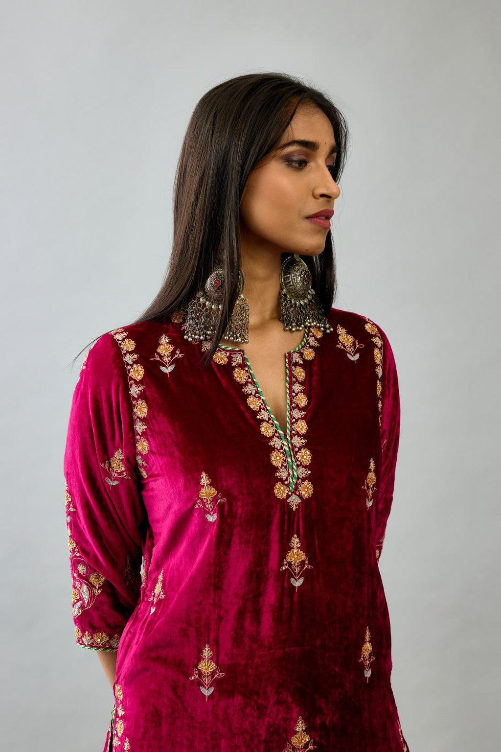 Fuchsia silk velvet straight kurta set with all-over zari, dori and contrast silk thread embroidery, highlighted with gold sequins work.