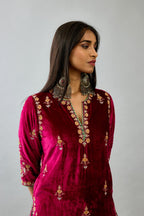 Fuchsia silk velvet straight kurta set with all-over zari, dori and contrast silk thread embroidery, highlighted with gold sequins work.