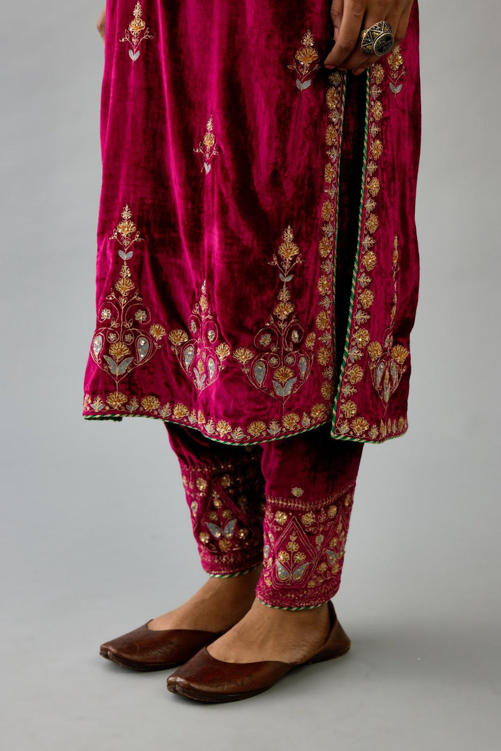 Fuchsia silk velvet straight kurta set with all-over zari, dori and contrast silk thread embroidery, highlighted with gold sequins work.