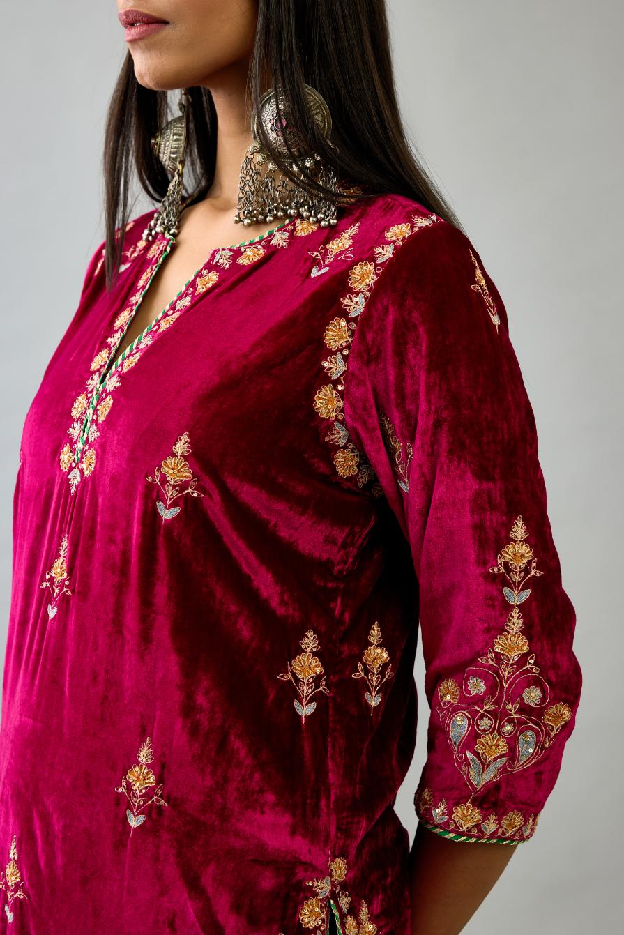 Fuchsia silk velvet straight kurta set with all-over zari, dori and contrast silk thread embroidery, highlighted with gold sequins work.