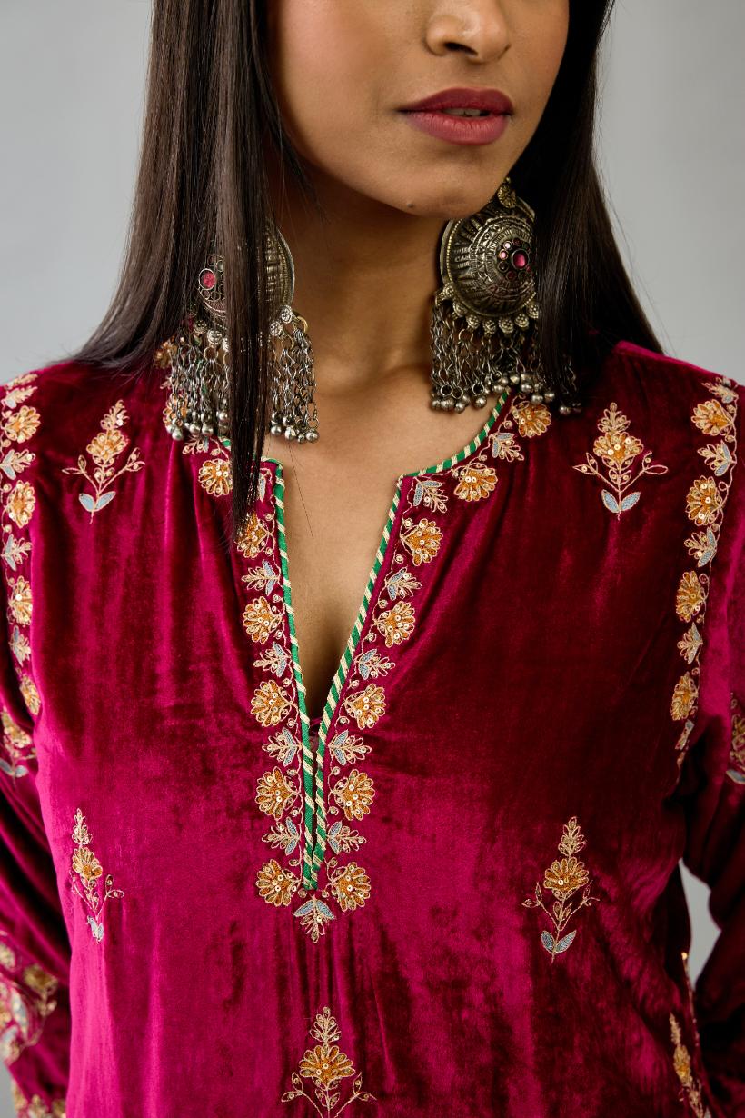 Fuchsia silk velvet straight kurta set with all-over zari, dori and contrast silk thread embroidery, highlighted with gold sequins work.