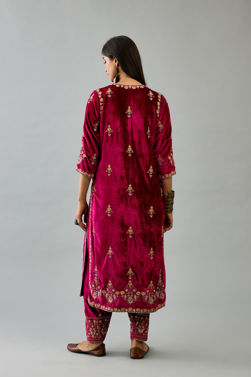 Fuchsia silk velvet straight kurta set with all-over zari, dori and contrast silk thread embroidery, highlighted with gold sequins work.