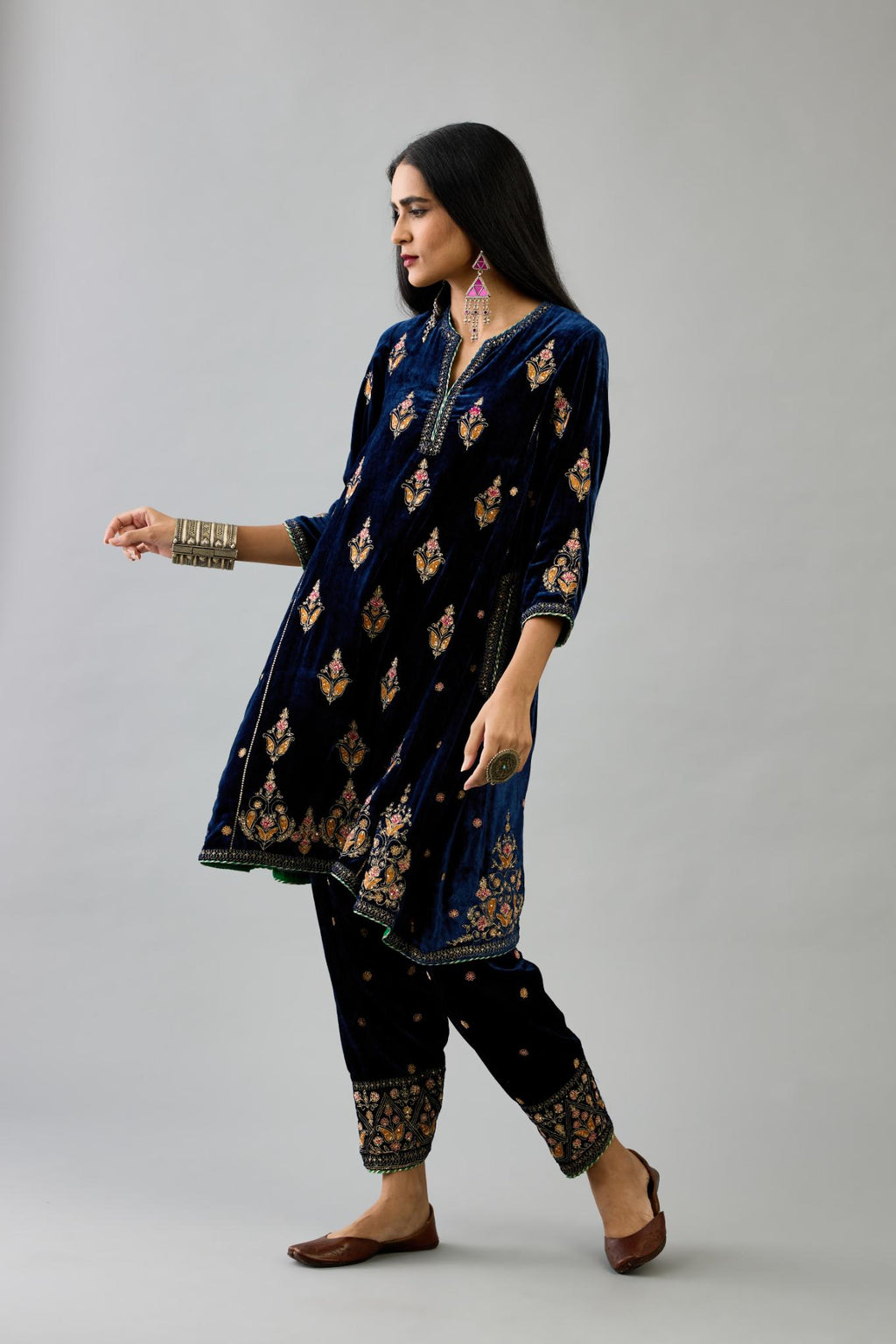 Blue silk velvet A-line short kurta set with dori and contrast silk thread embroidery, highlighted with gold sequins work.