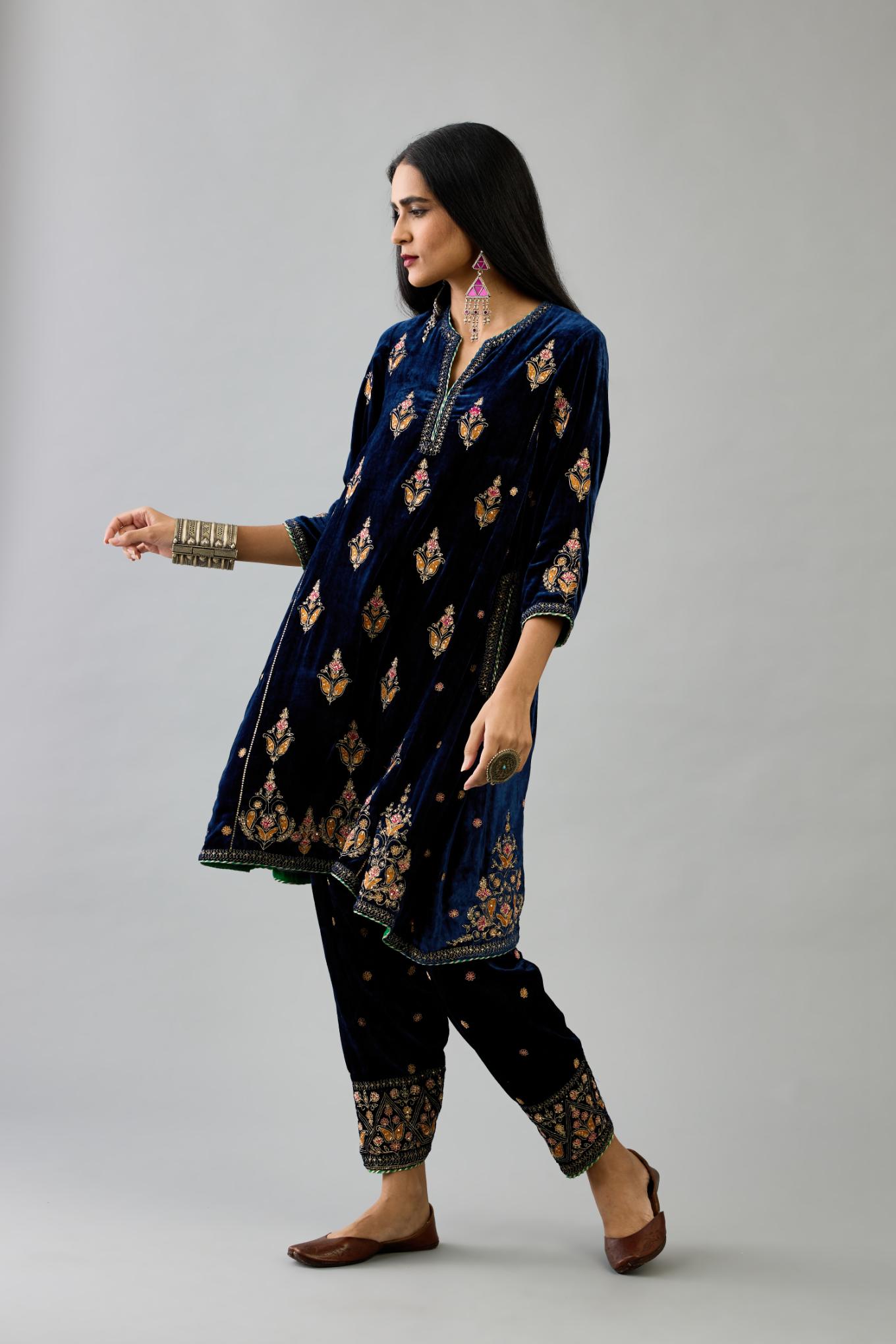 Blue silk velvet A-line short kurta set with dori and contrast silk thread embroidery, highlighted with gold sequins work.