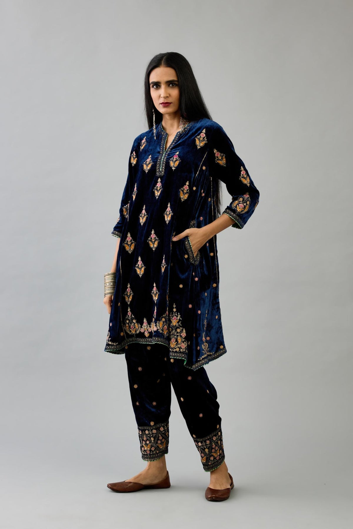 Blue silk velvet A-line short kurta set with dori and contrast silk thread embroidery, highlighted with gold sequins work.