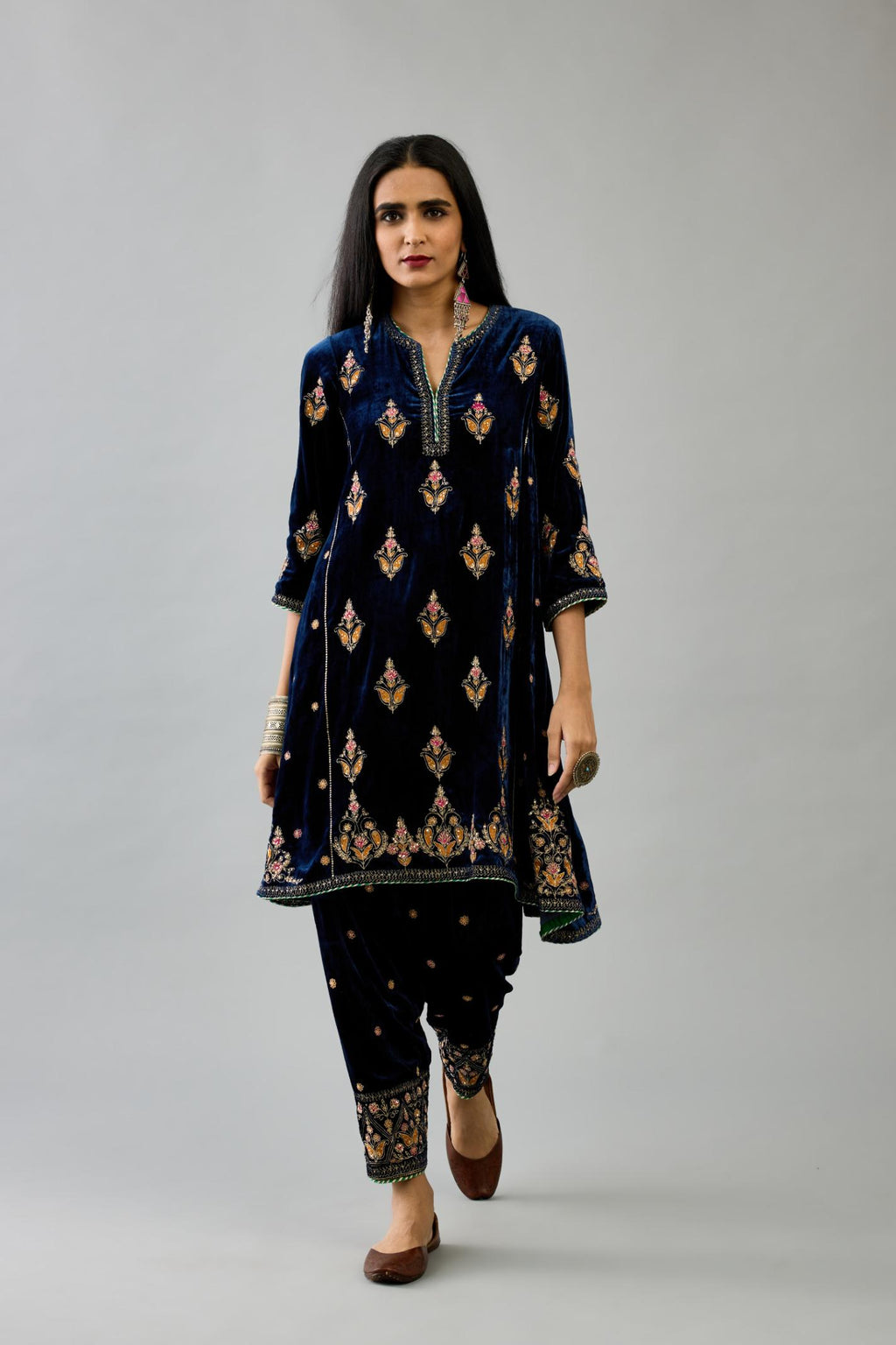 Blue silk velvet A-line short kurta set with dori and contrast silk thread embroidery, highlighted with gold sequins work.