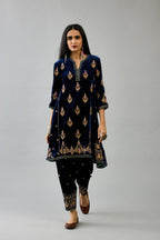 Blue silk velvet A-line short kurta set with dori and contrast silk thread embroidery, highlighted with gold sequins work.