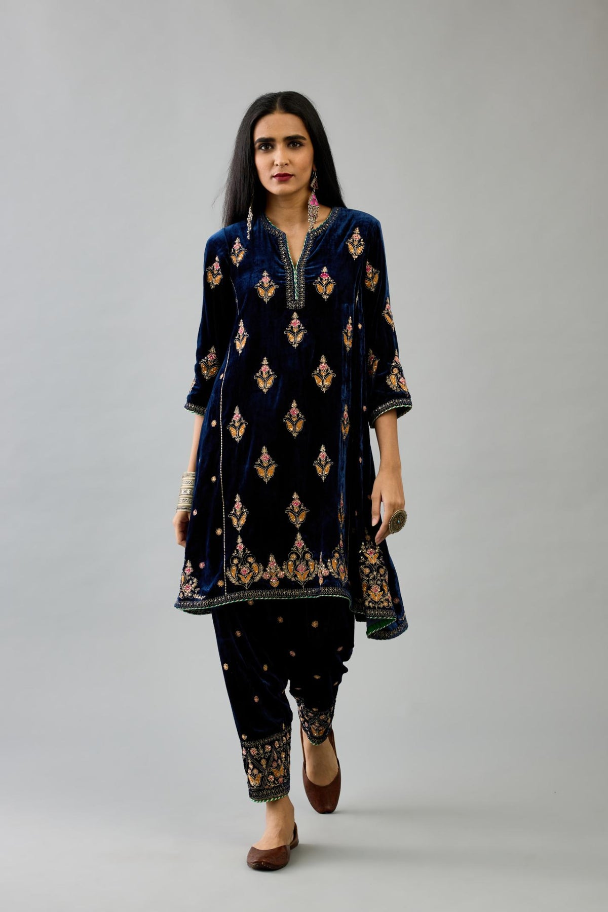 Blue silk velvet A-line short kurta set with dori and contrast silk thread embroidery, highlighted with gold sequins work.