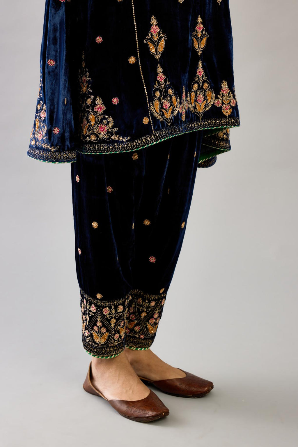 Blue silk velvet A-line short kurta set with dori and contrast silk thread embroidery, highlighted with gold sequins work.