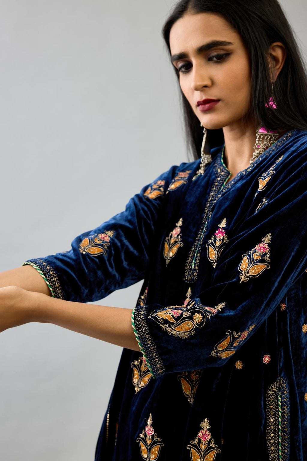 Blue silk velvet A-line short kurta set with dori and contrast silk thread embroidery, highlighted with gold sequins work.