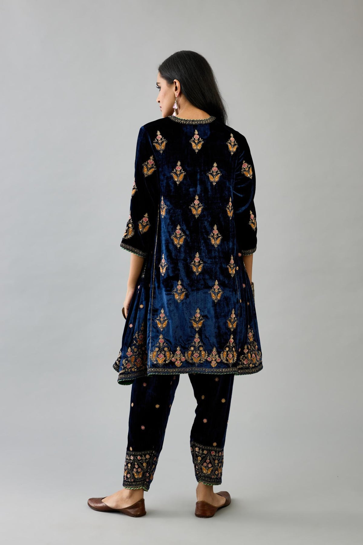 Blue silk velvet A-line short kurta set with dori and contrast silk thread embroidery, highlighted with gold sequins work.