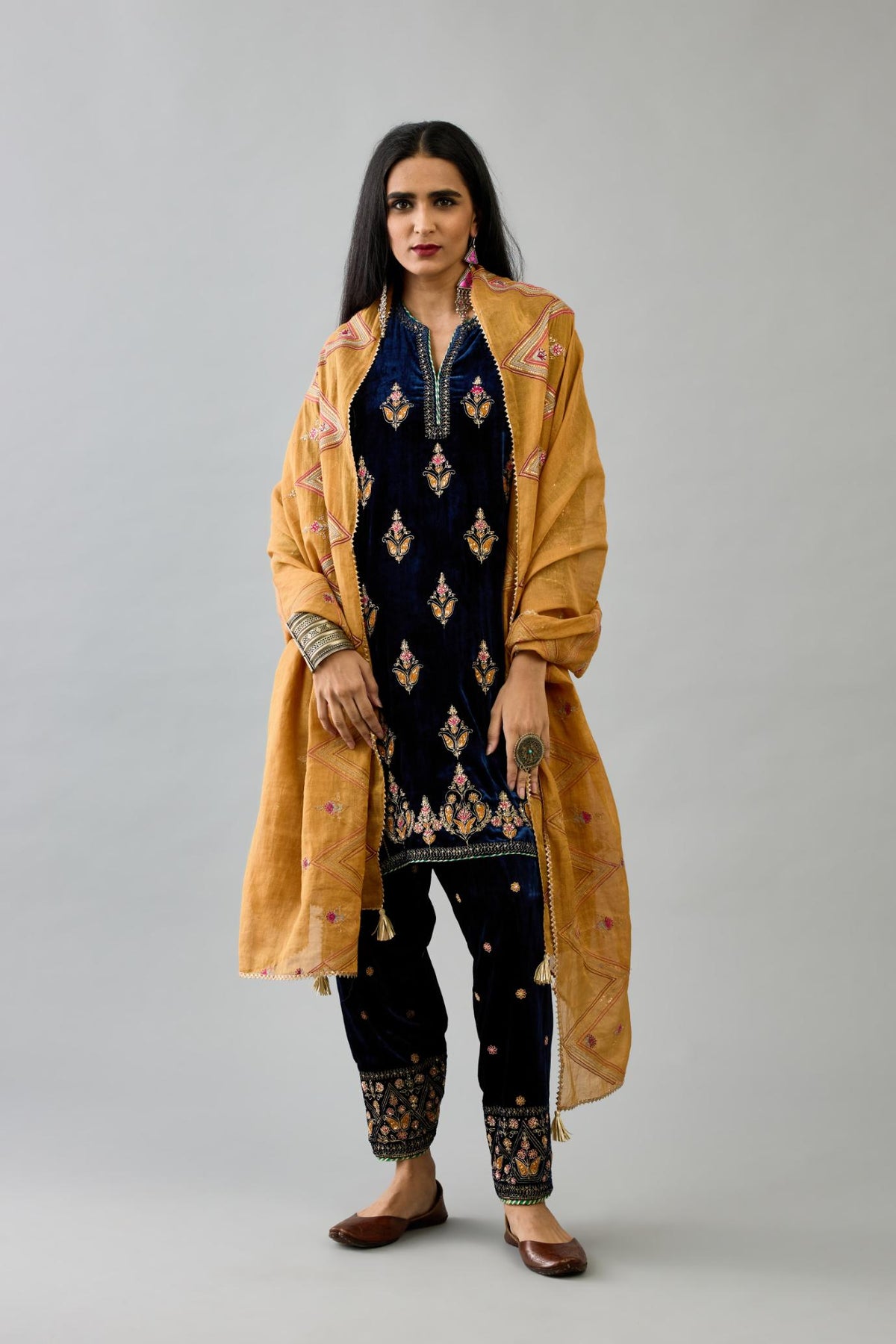 Blue silk velvet A-line short kurta set with dori and contrast silk thread embroidery, highlighted with gold sequins work.
