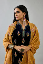 Blue silk velvet A-line short kurta set with dori and contrast silk thread embroidery, highlighted with gold sequins work.