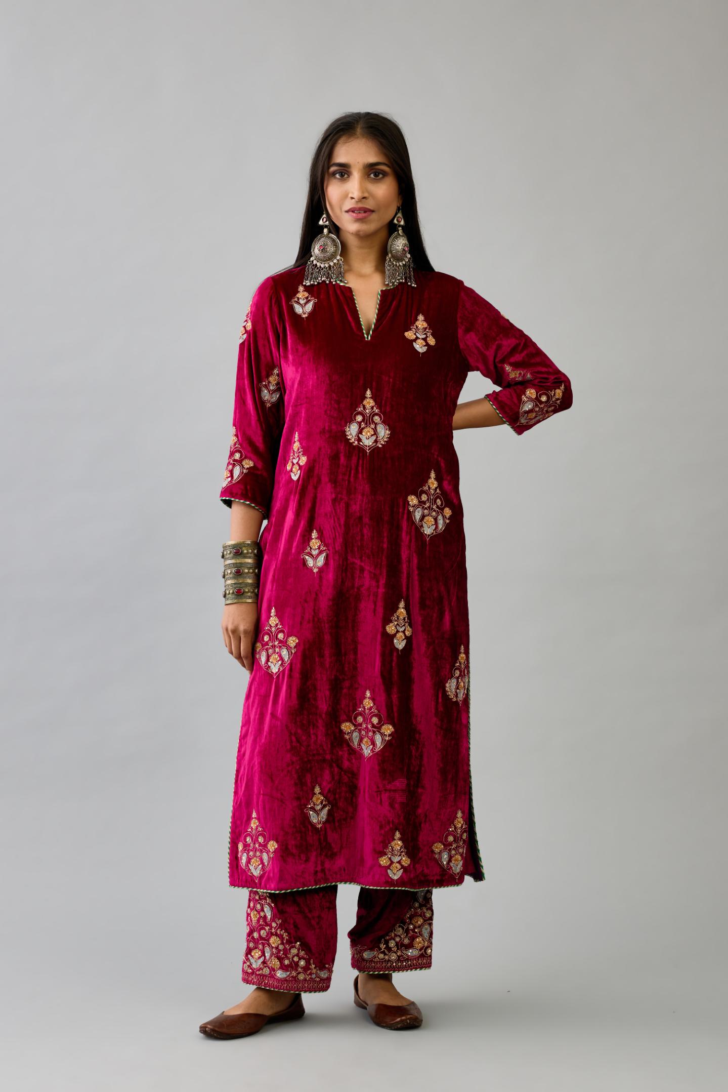 Fuchsia silk velvet straight kurta set with zari, dori and contrast silk thread embroidered bootas, highlighted with gold sequins work.