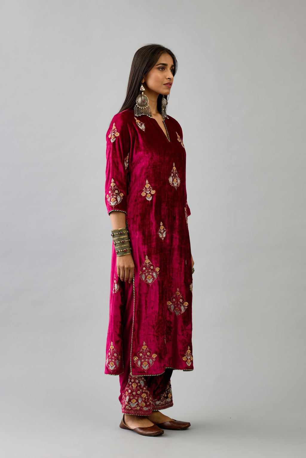 Fuchsia silk velvet straight kurta set with zari, dori and contrast silk thread embroidered bootas, highlighted with gold sequins work.