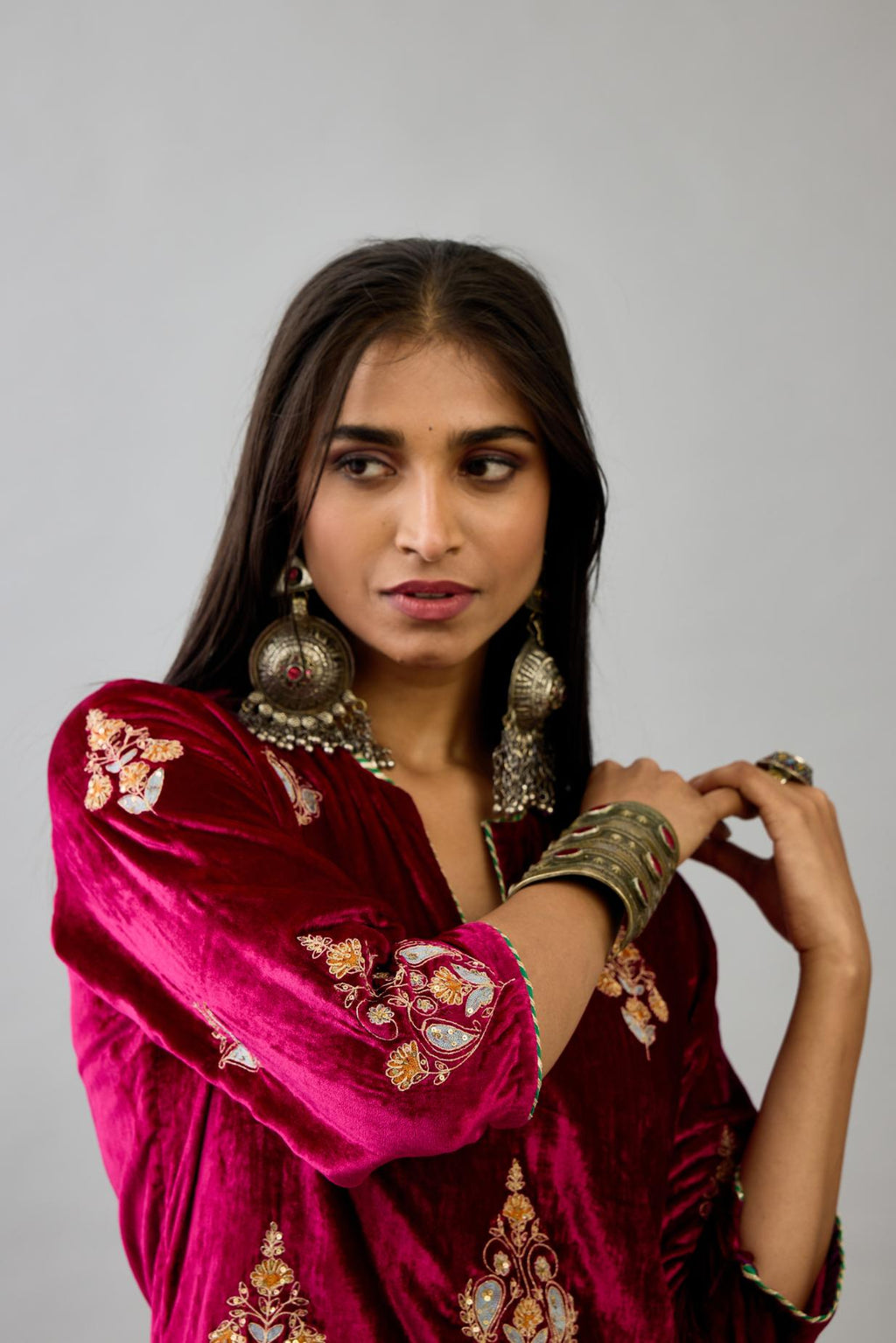 Fuchsia silk velvet straight kurta set with zari, dori and contrast silk thread embroidered bootas, highlighted with gold sequins work.