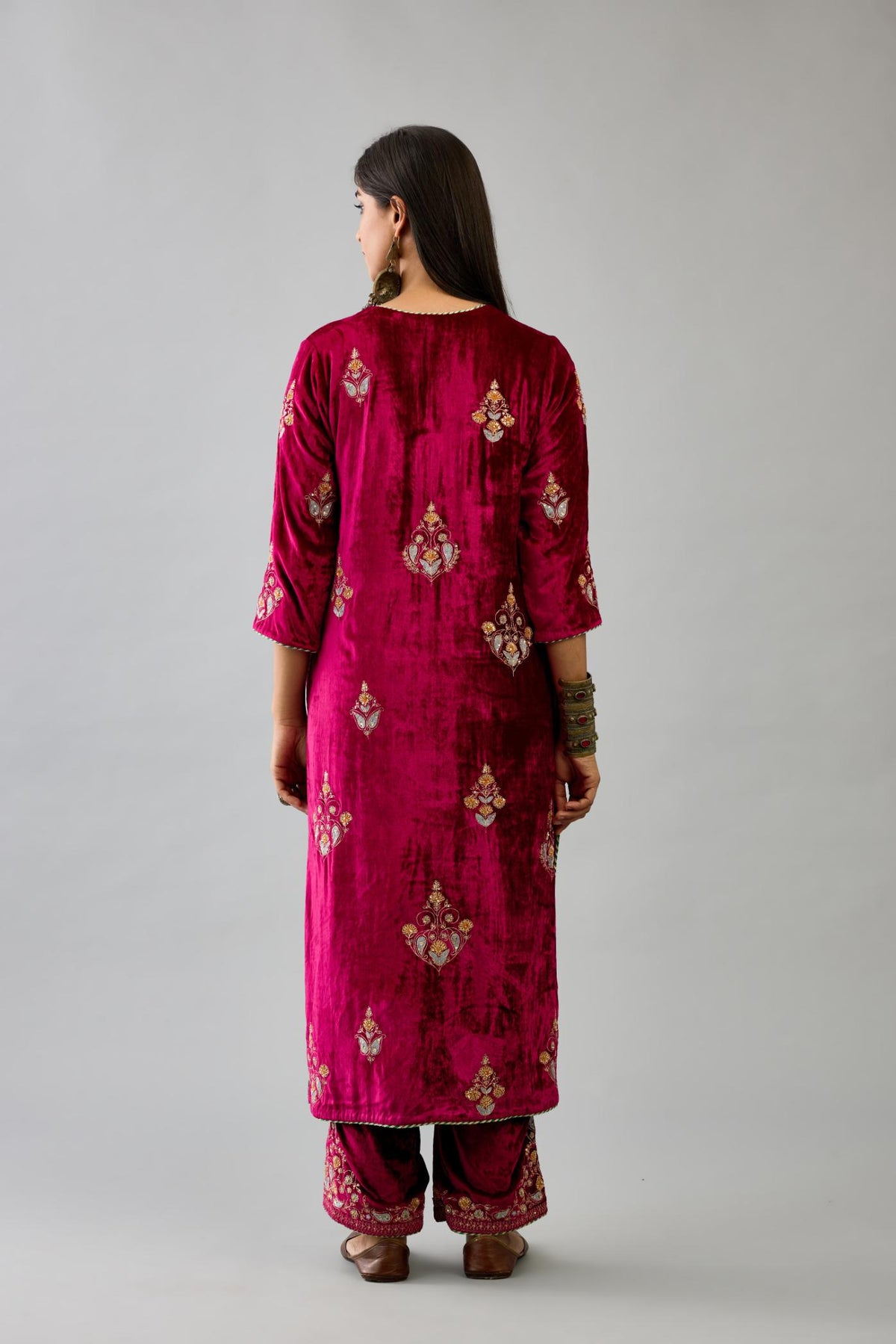 Fuchsia silk velvet straight kurta set with zari, dori and contrast silk thread embroidered bootas, highlighted with gold sequins work.