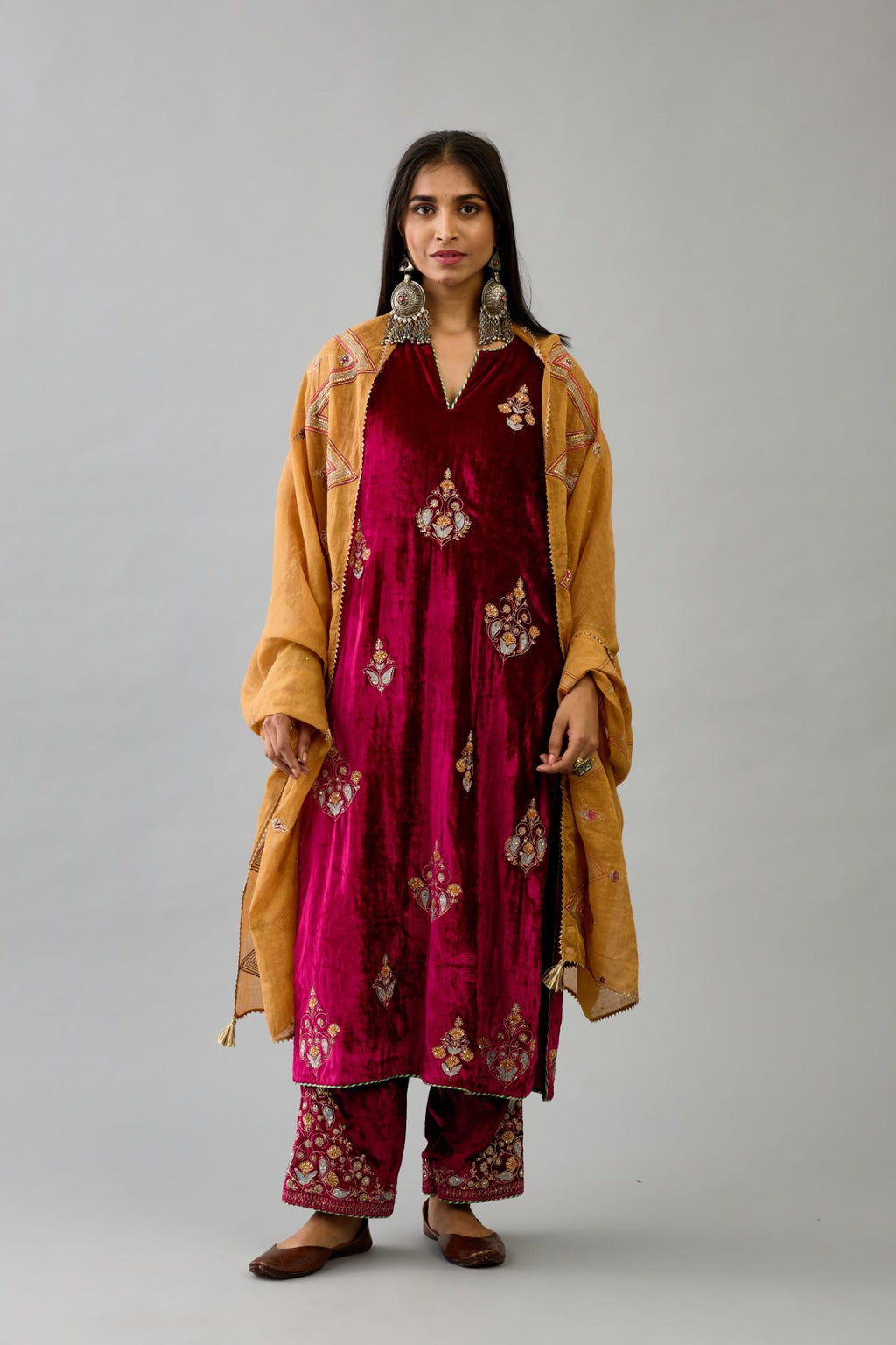 Fuchsia silk velvet straight kurta set with zari, dori and contrast silk thread embroidered bootas, highlighted with gold sequins work.