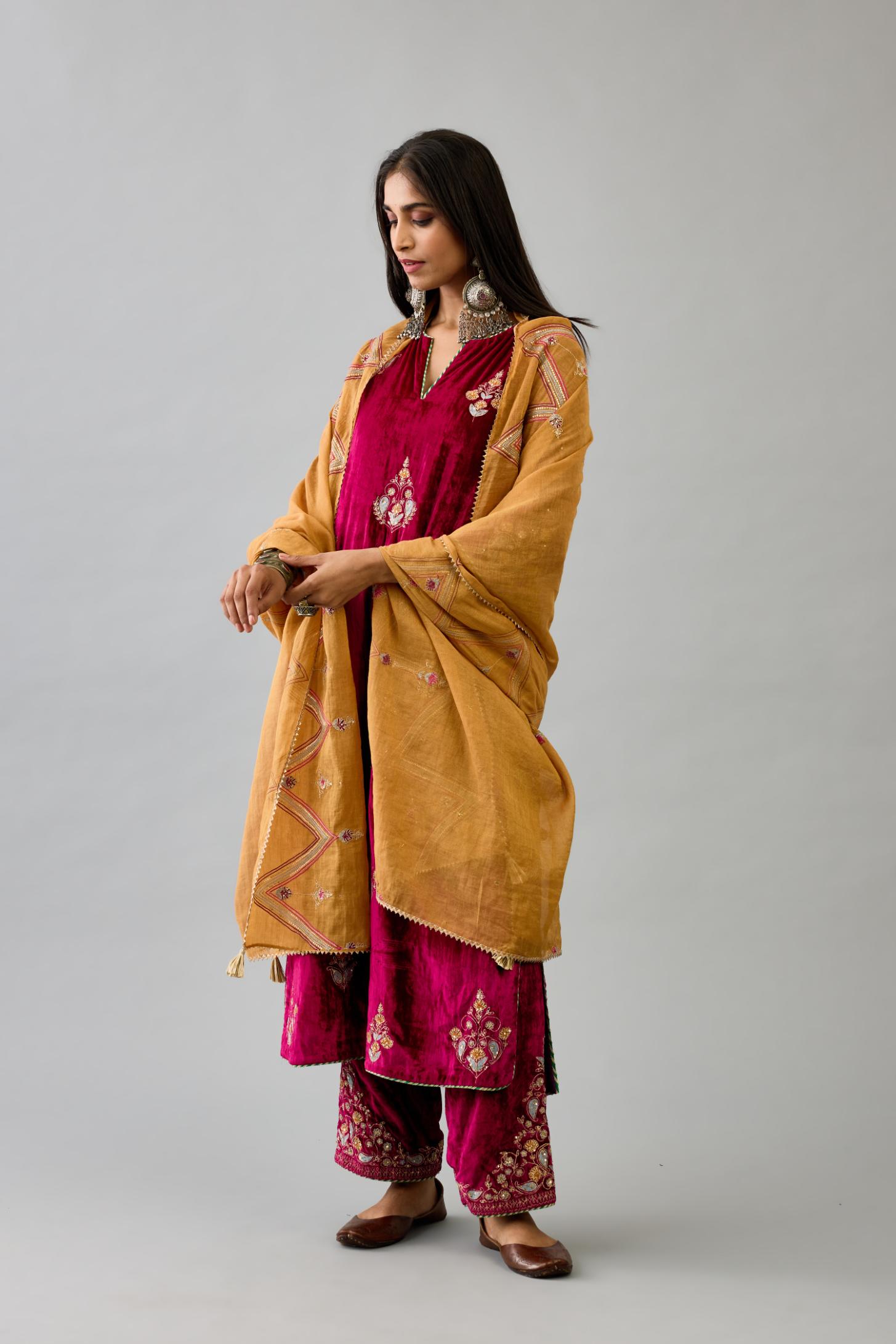 Fuchsia silk velvet straight kurta set with zari, dori and contrast silk thread embroidered bootas, highlighted with gold sequins work.