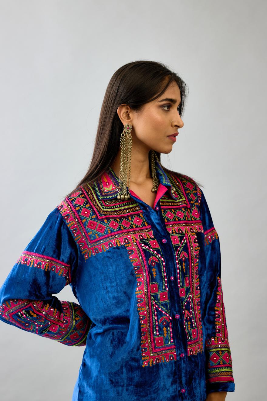 Blue silk velvet embroidered shirt with full sleeves, paired with blue silk velvet straight pants with all over contrast color embroidery detailed with sequins.