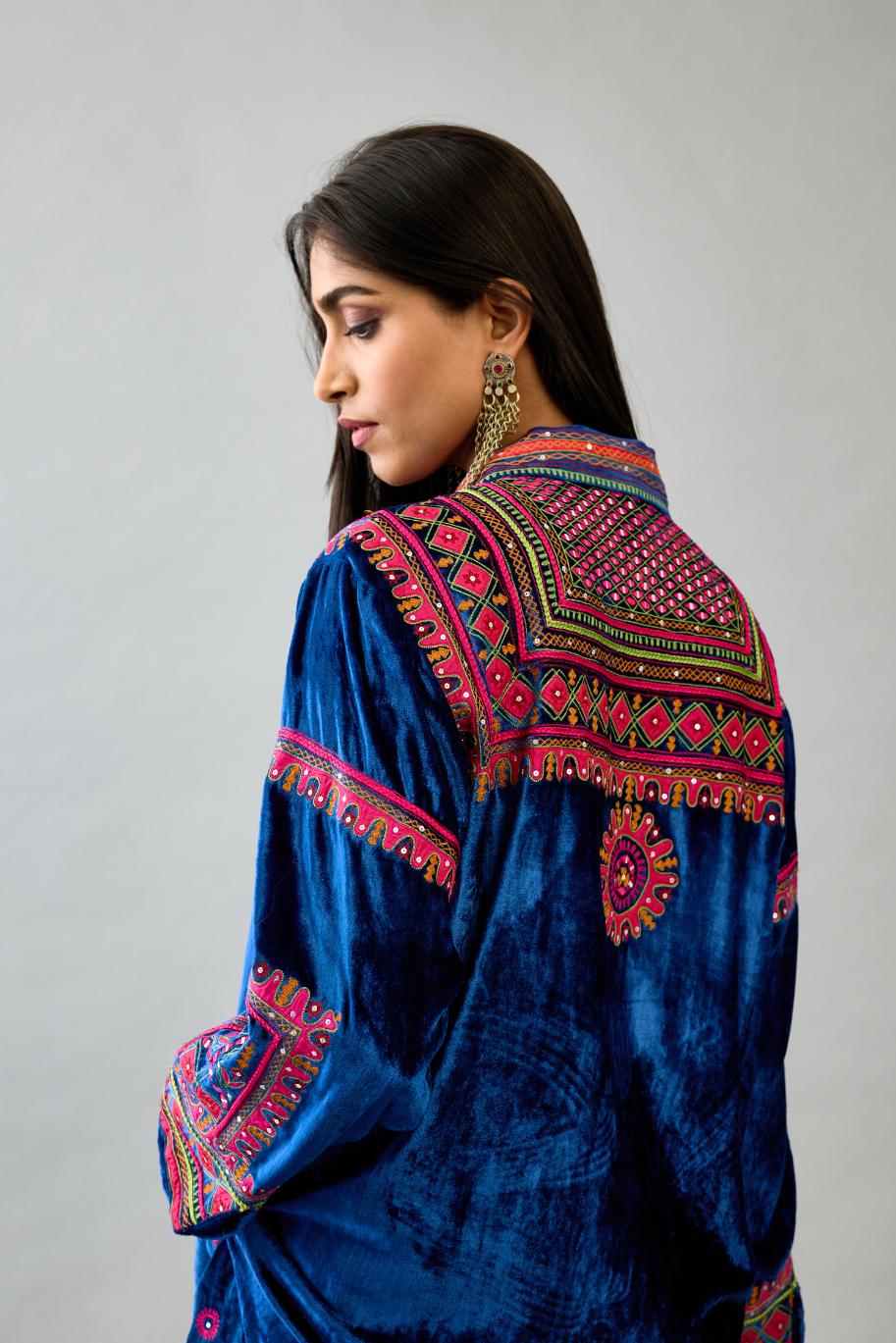 Blue silk velvet embroidered shirt with full sleeves, paired with blue silk velvet straight pants with all over contrast color embroidery detailed with sequins.