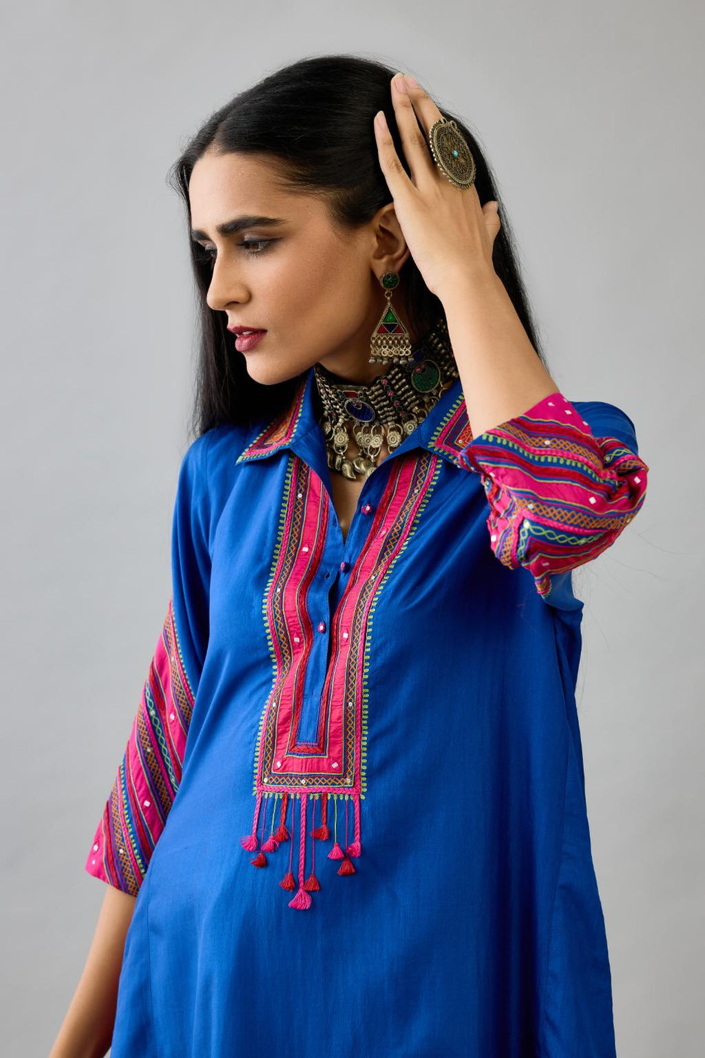 Blue Silk A-line kurta with collar, detailed with patchwork, silk thread embroidery, mirrors, sequins and tassels.