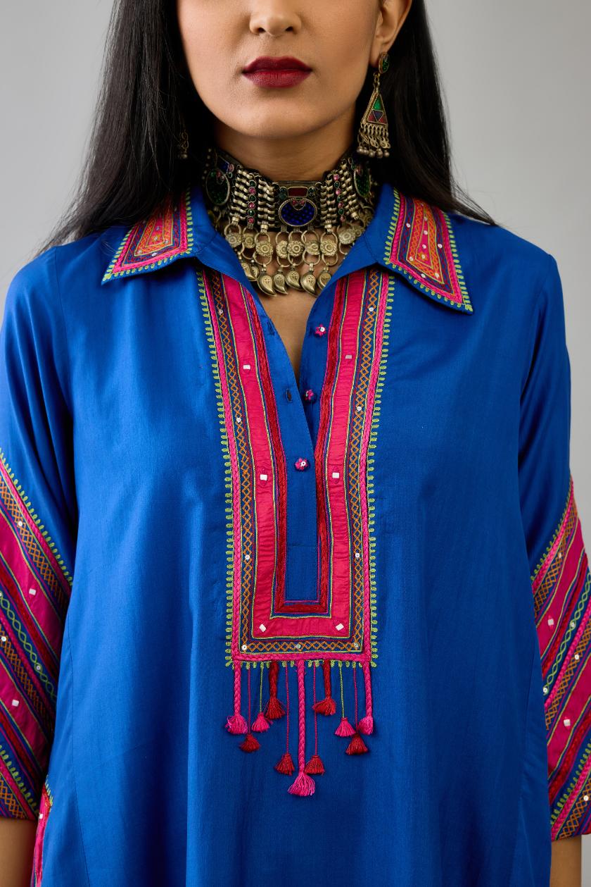 Blue Silk A-line kurta with collar, detailed with patchwork, silk thread embroidery, mirrors, sequins and tassels.