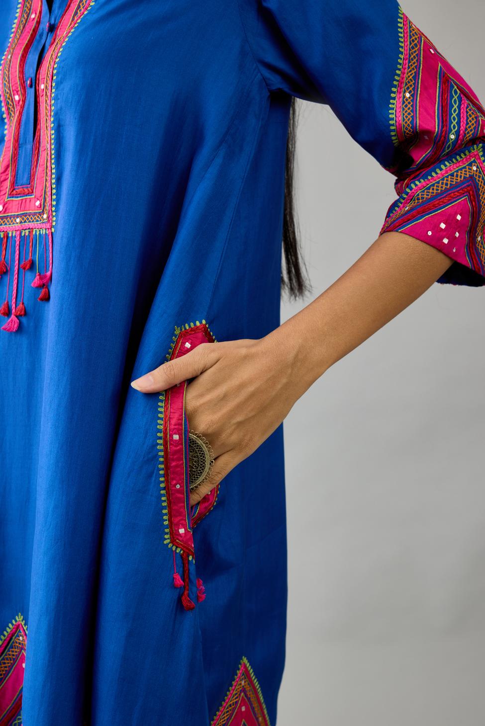 Blue Silk A-line kurta with collar, detailed with patchwork, silk thread embroidery, mirrors, sequins and tassels.