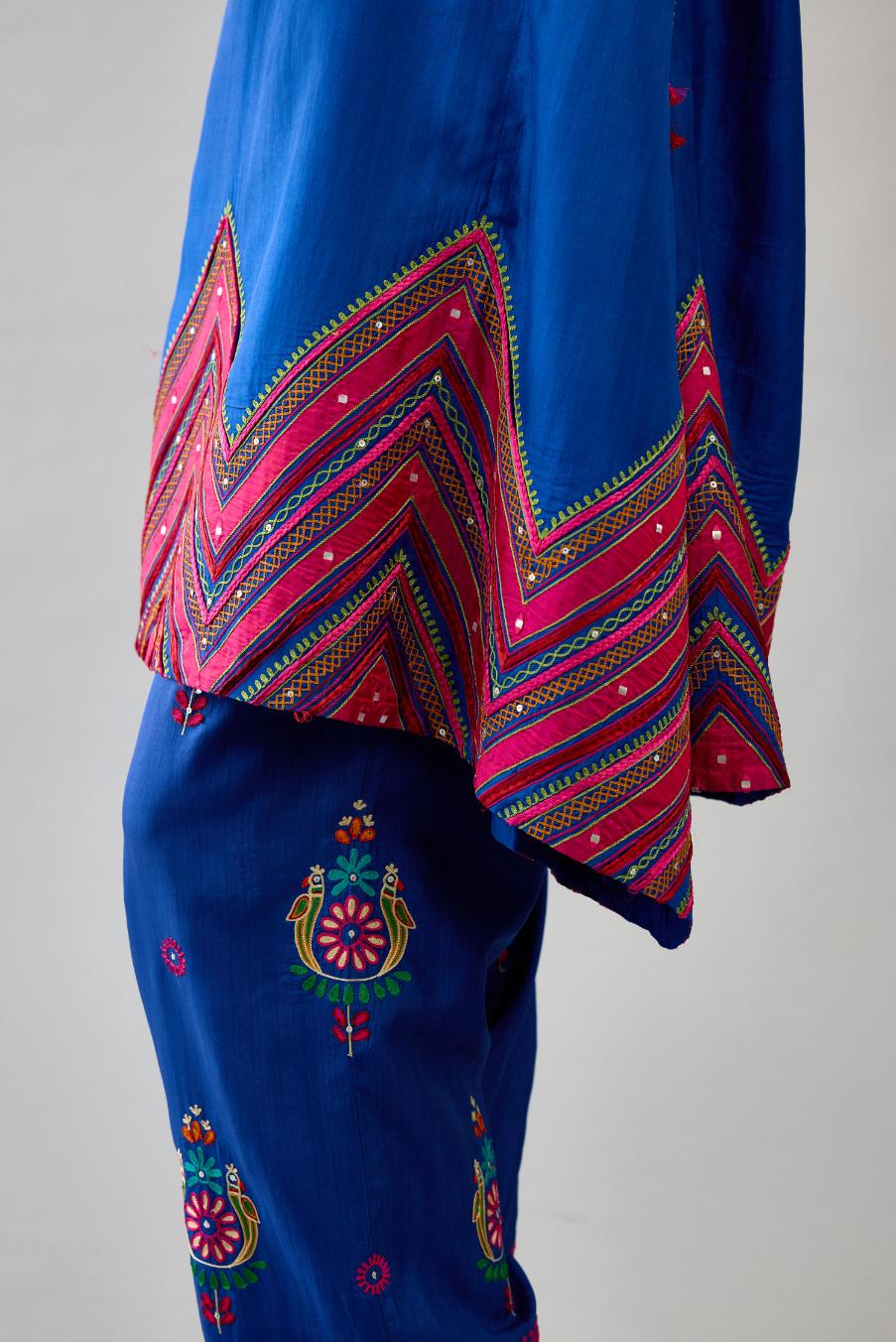 Blue Silk A-line kurta with collar, detailed with patchwork, silk thread embroidery, mirrors, sequins and tassels.