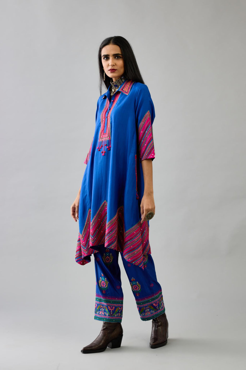 Blue Silk A-line kurta with collar, detailed with patchwork, silk thread embroidery, mirrors, sequins and tassels.